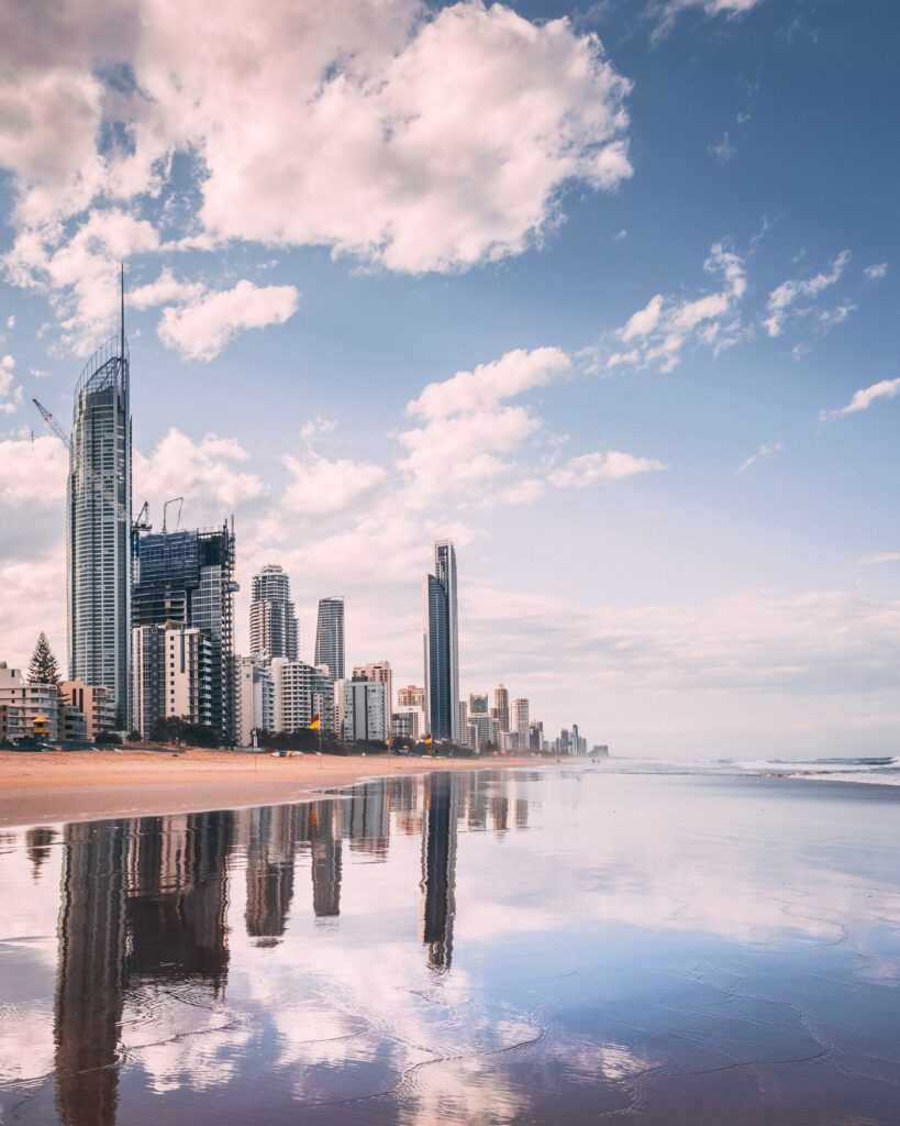 Vertical shot of a beach in the background of highrise buildings in Goldcoast, Australia